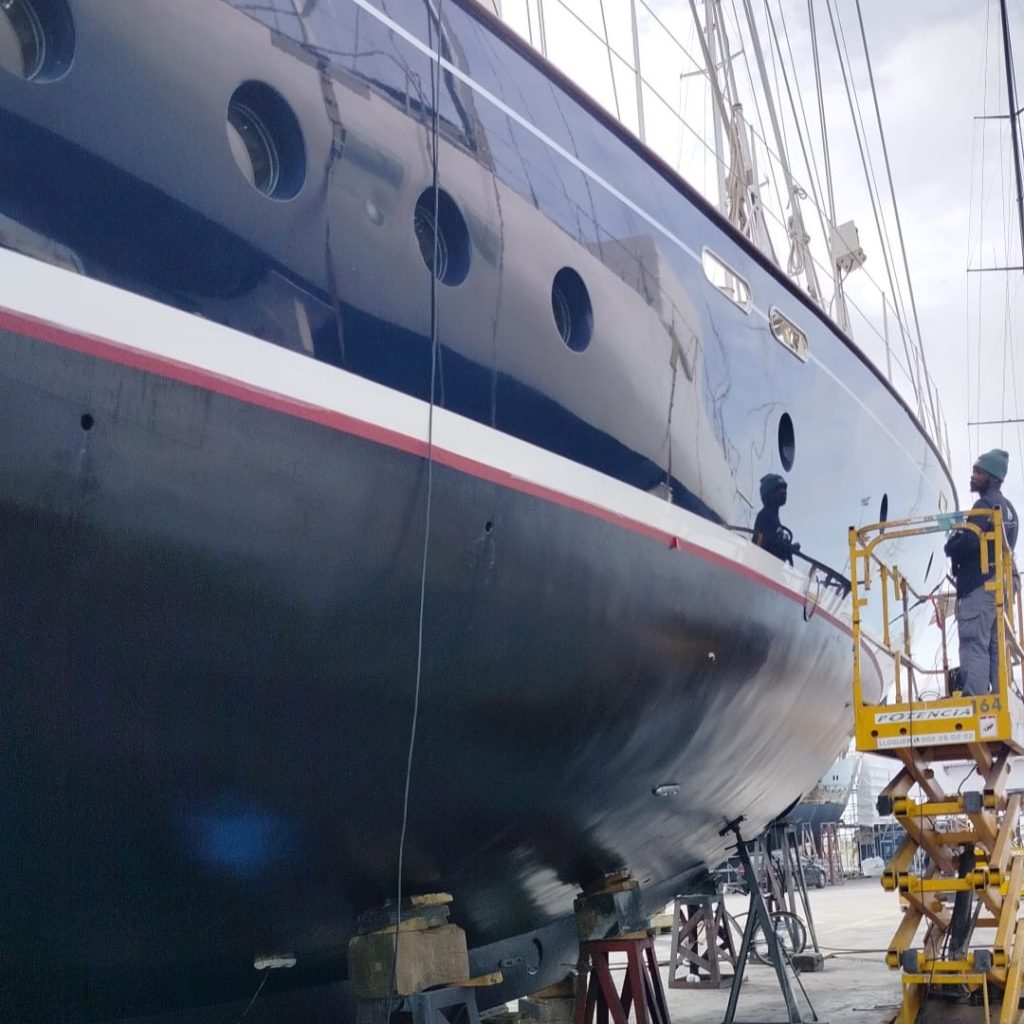worker from promarine coatings painting a sailing yacht in mallorca